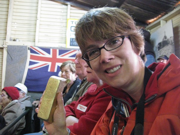 n_img_4097__heather__a_canadian_in_our_group__with_a_simulated_gold_brick_from_a_demonstration_of_the_pouring_technique__a_simulated___600_000__.jpg