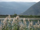 IMG_3616 Lake and flat valley bottom, Roman tower, modern elevated road across the face of the precipitous hillside.JPG