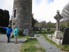 IMG_2725 The round tower of Glendalough, our guide, and Robert..JPG