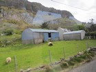 IMG_4029  Round-roofed barns and black rocky Knockore Mtn..JPG